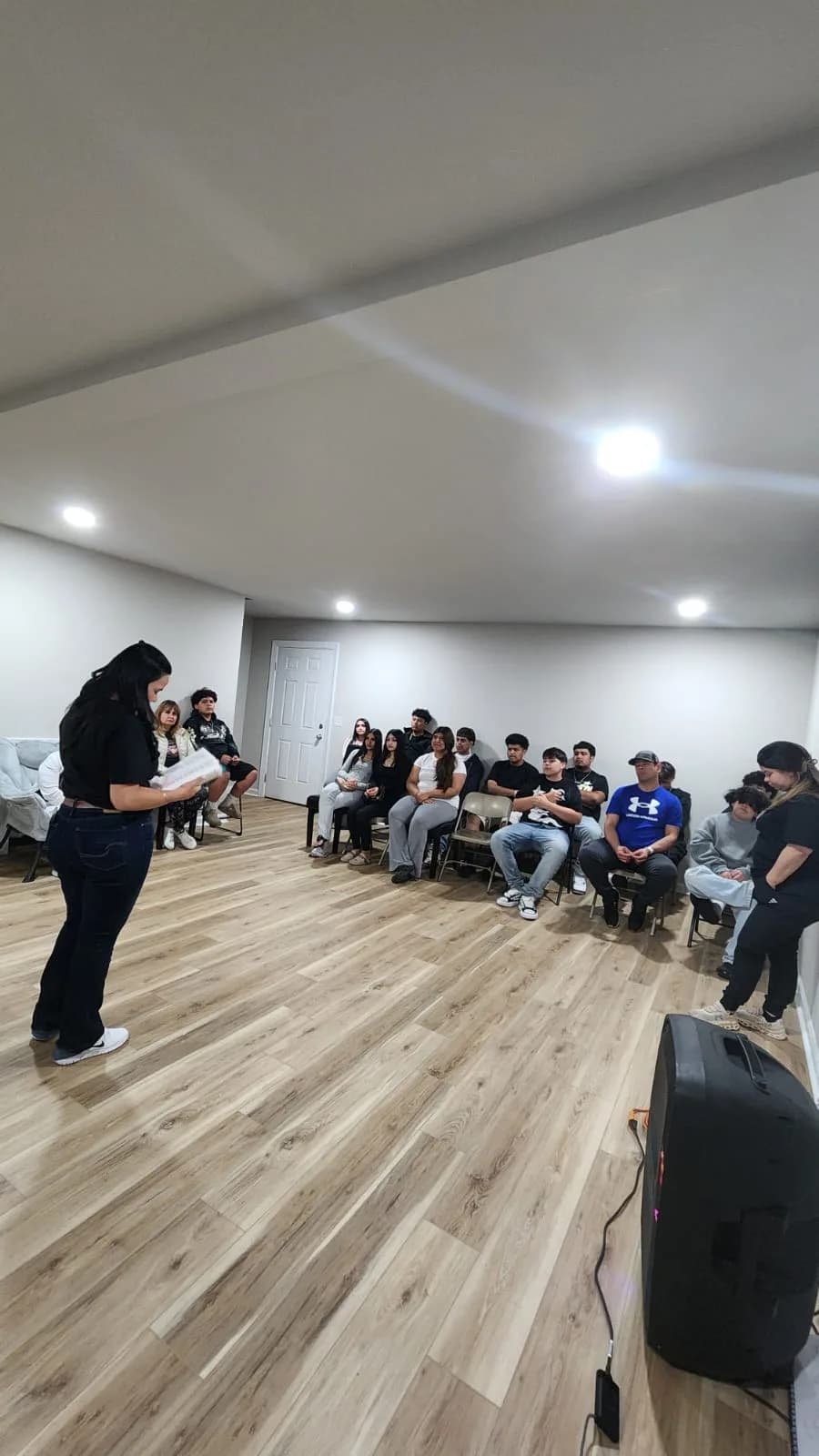 The founder of standuptogether speaking to a group of young people during a mentoring session