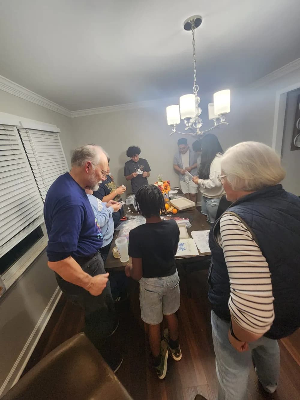 Intergenerational group from standuptogether doing crafts together at a family activity